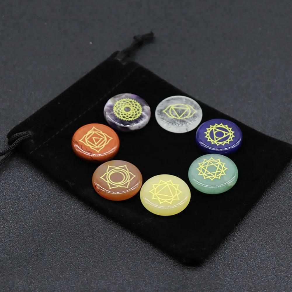 Natural 7 Chakra engraved crystal coins on a black pouch for meditation, healing, and balancing energy centers.