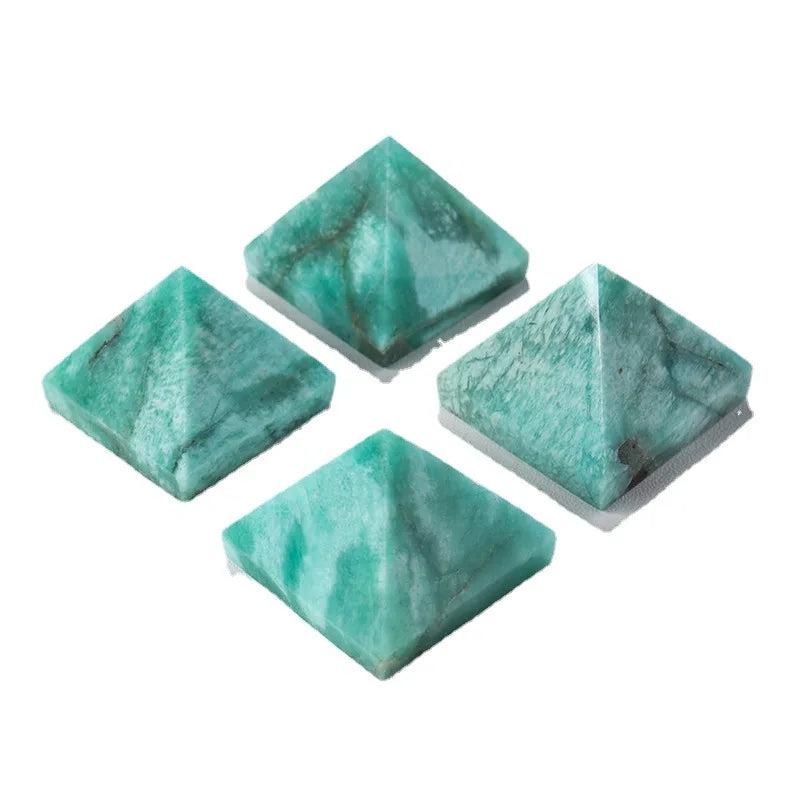Four natural Amazonite Crystal Pyramids in varying soft blue-green hues for healing and calm.