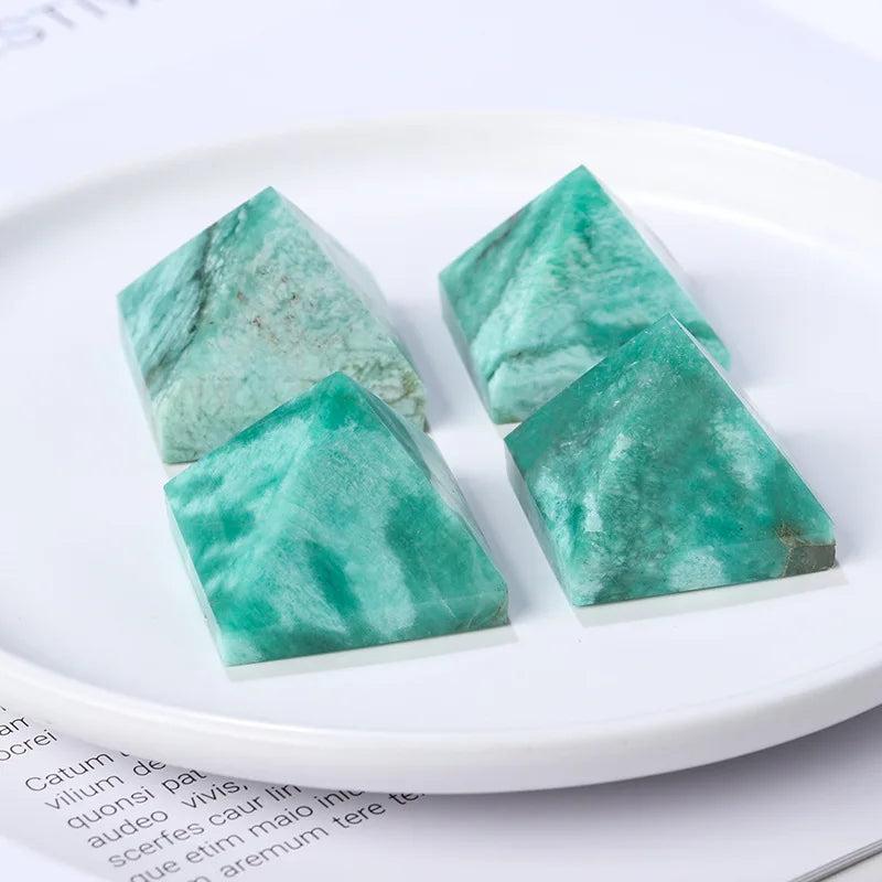 Four natural Amazonite crystal pyramids, 30-50mm, with blue-green hues and unique patterns, for healing and decor.