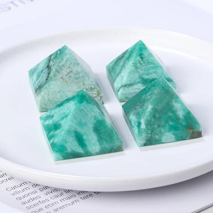 Natural Amazonite Crystal Pyramids in varying blue-green hues, perfect for healing and calm.