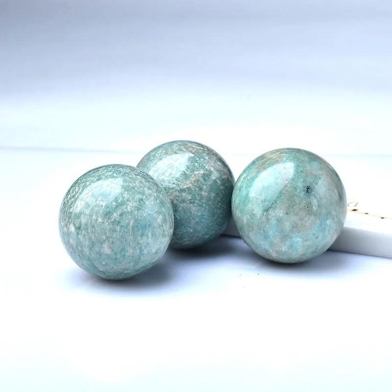 Three polished Natural Amazonite Crystal Spheres, soft sky blue-green with natural mineral patterns, for peace and tranquility.