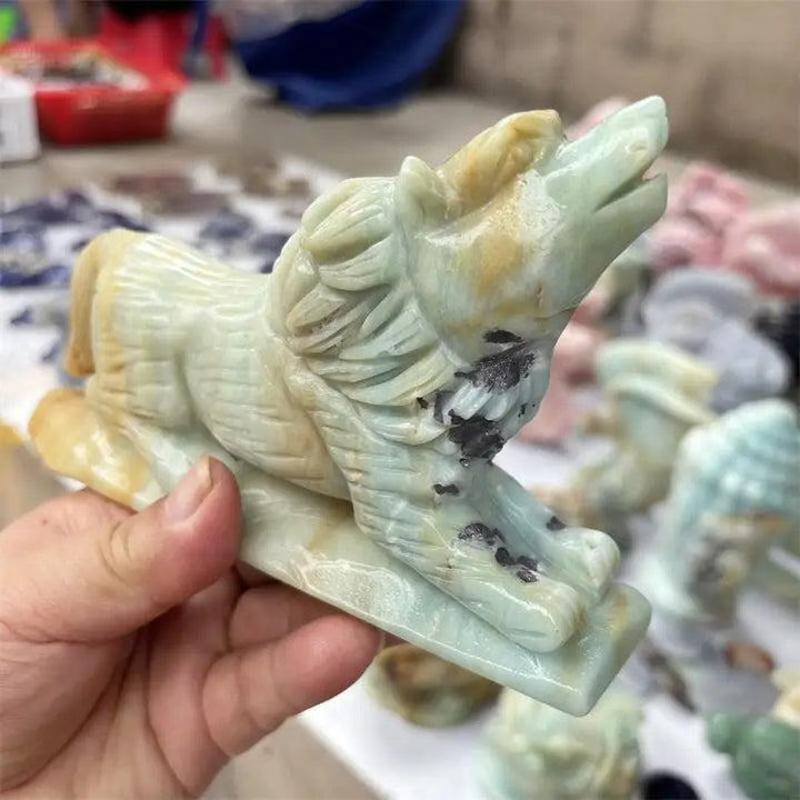 Polished Amazonite wolf carving in light green and tan, a healing stone for home decor.