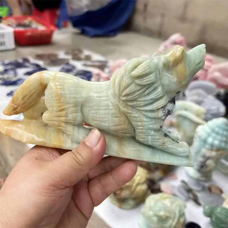 Hand-carved Amazonite wolf howling, featuring natural blue-green and beige hues, ideal for home decor and healing.