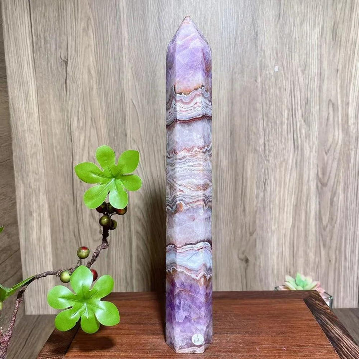 Natural amethyst skinny tower with purple, white, and brown bands, a healing crystal for home decor.