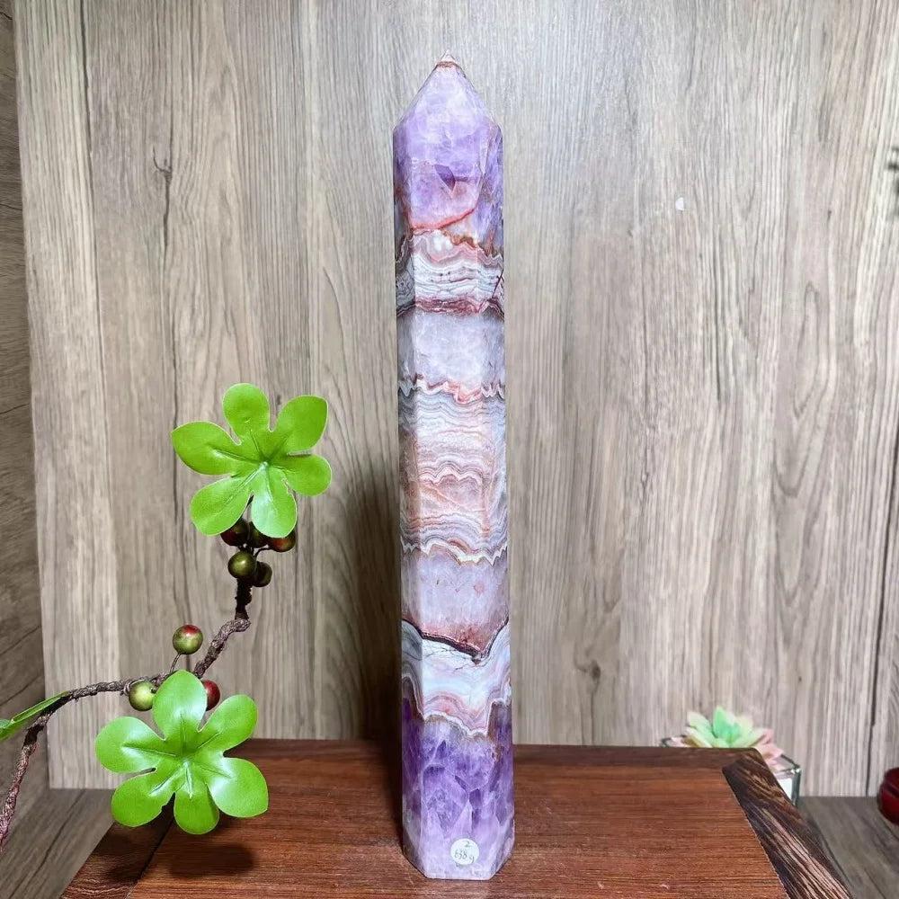 Natural amethyst skinny tower with purple and white bands, a pointed top, for healing and home decor.
