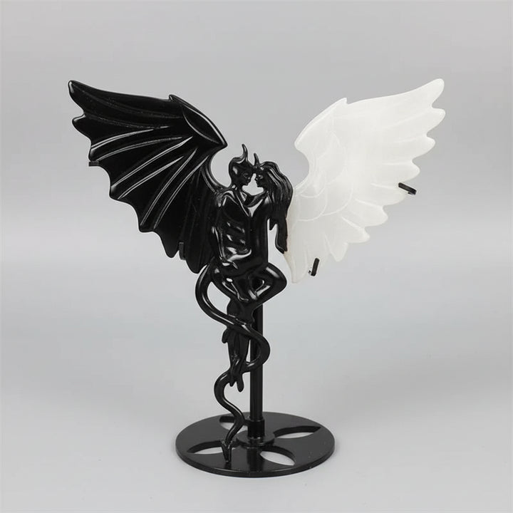 Natural black obsidian and white selenite wing demon couple statue, a polished healing crystal ornament for home decor.