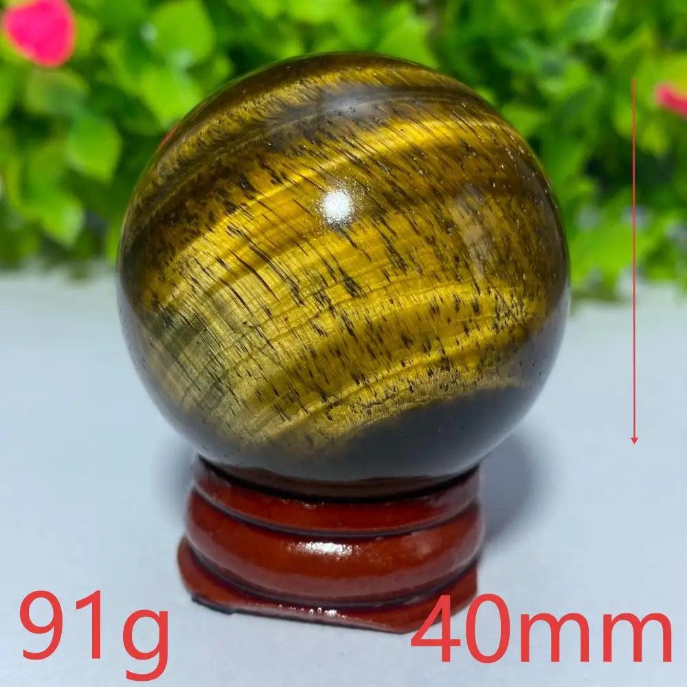 40mm natural yellow Tiger Eye crystal ball for Reiki healing and meditation, featuring a polished, golden-brown finish.