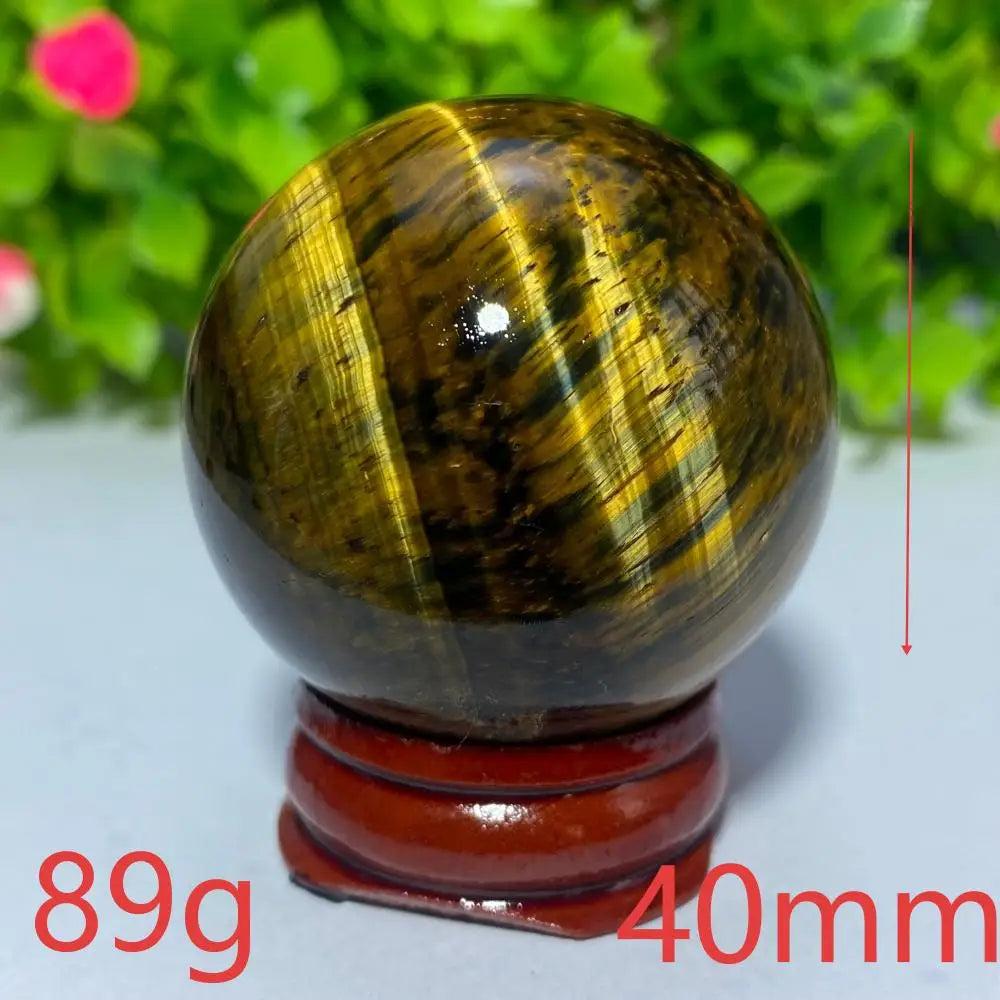 40mm natural Tiger Eye crystal ball for Reiki healing, featuring golden-brown chatoyant bands for meditation and decor.