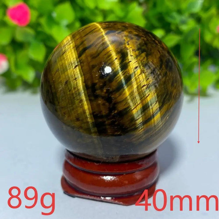 40mm natural Tiger Eye crystal ball for Reiki healing, featuring golden-brown chatoyant bands for meditation and decor.