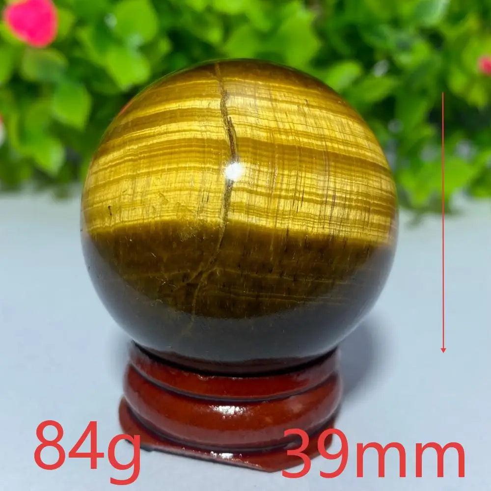 39mm natural yellow Tiger Eye crystal ball for Reiki healing and meditation, featuring a polished, banded golden sphere.