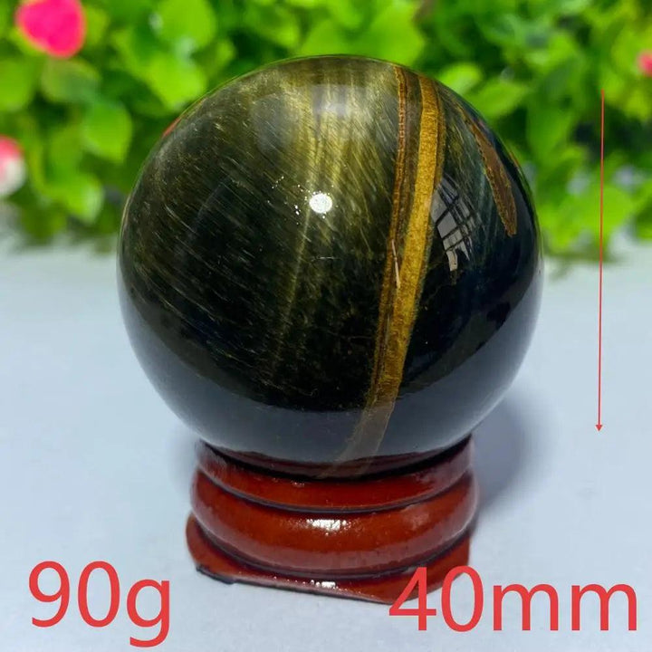 40mm Natural Blue Yellow Tiger Eye crystal ball on a wooden stand, perfect for Reiki healing and spiritual home decor.