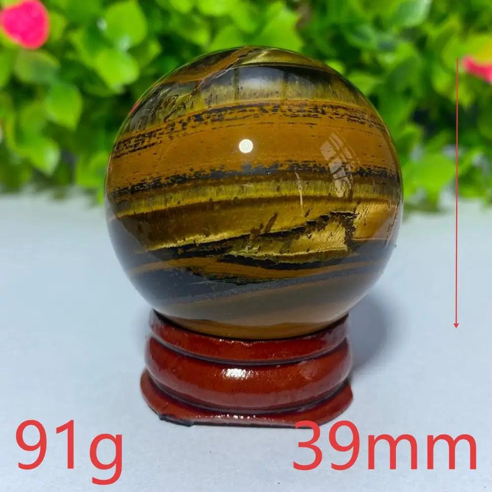 39mm Natural Tiger Eye crystal ball on a wooden stand, perfect for Reiki healing, meditation, and spiritual home decor.