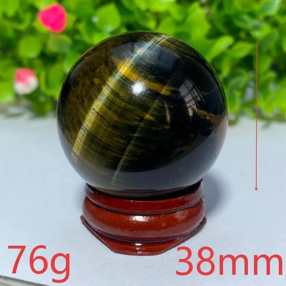 38mm natural blue and yellow Tiger Eye crystal ball on a wooden stand, perfect for Reiki healing and spiritual decor.