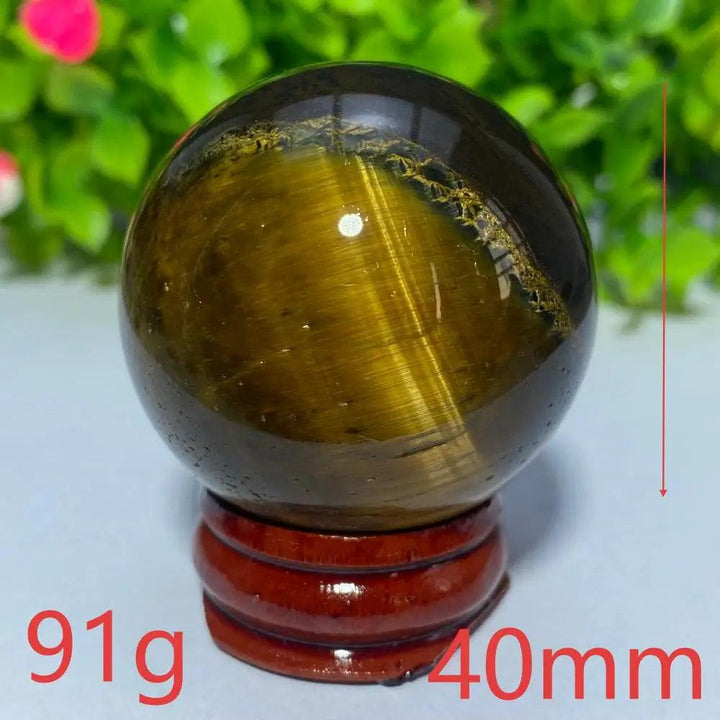 40mm Natural Blue Yellow Tiger Eye crystal ball for Reiki healing and meditation, featuring a polished golden sphere.