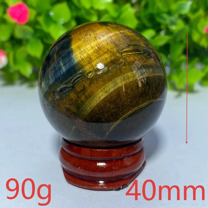 40mm Natural Blue and Yellow Tiger Eye crystal ball on a wooden stand, perfect for Reiki healing and spiritual decor.