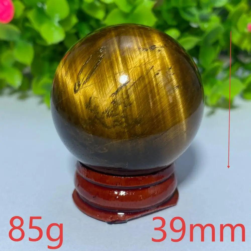 Polished 39mm Blue Yellow Tiger Eye crystal ball, 85g healing stone sphere on a wooden stand for meditation and decor.