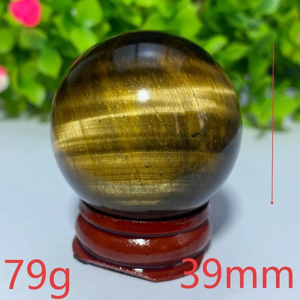 Polished 39mm natural yellow tiger eye crystal ball for Reiki healing, meditation, and spiritual home decor.