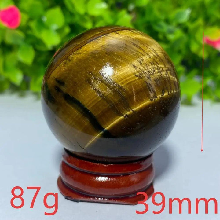 Polished 39mm natural blue and yellow Tiger Eye crystal ball on a wooden stand, perfect for Reiki and meditation.