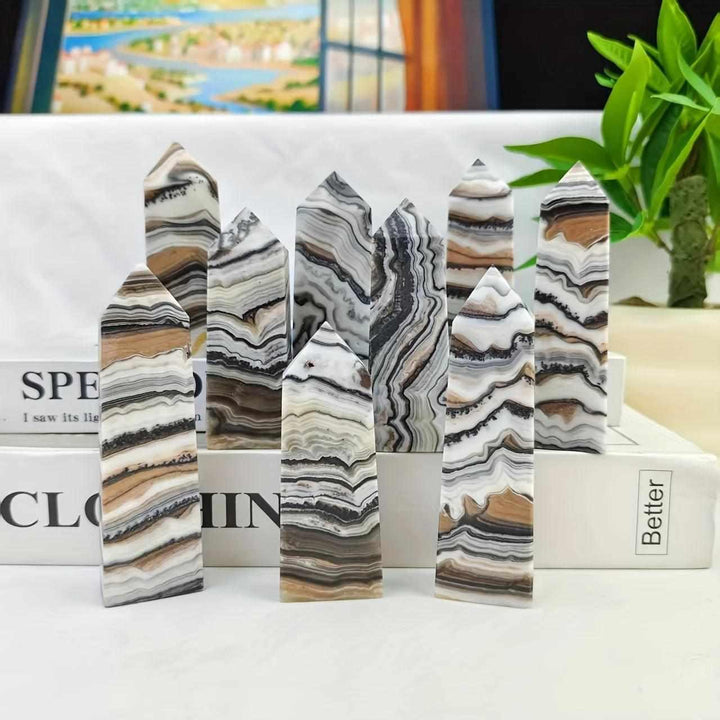 Polished chocolate calcite crystal towers with earthy brown and white banded patterns for grounding root chakra energy.