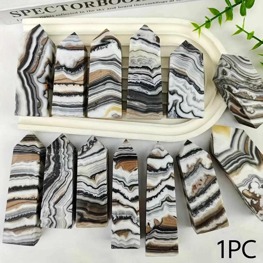 Polished chocolate calcite crystal towers with earthy brown, black, and white bands for grounding root chakra energy.