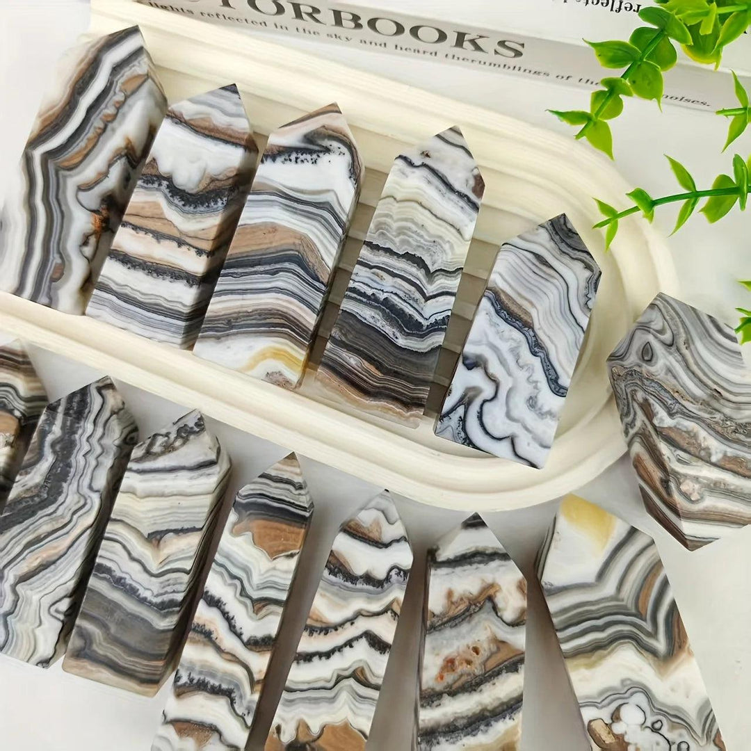 Polished chocolate calcite crystal towers with earthy brown, tan, and white bands for grounding root chakra energy.