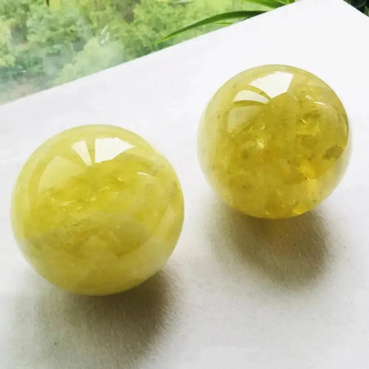 Two polished Natural Citrine Quartz Spheres from Crystal Destiny, radiating warm golden-yellow hues for abundance and joy.