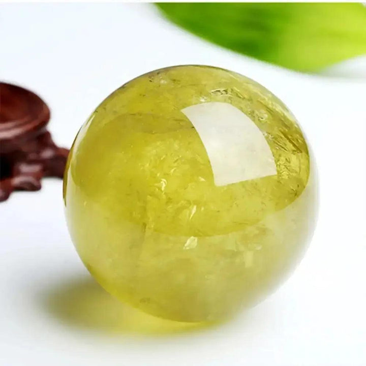 Polished natural citrine quartz sphere from Crystal Destiny, radiating warm golden-yellow hues for abundance.