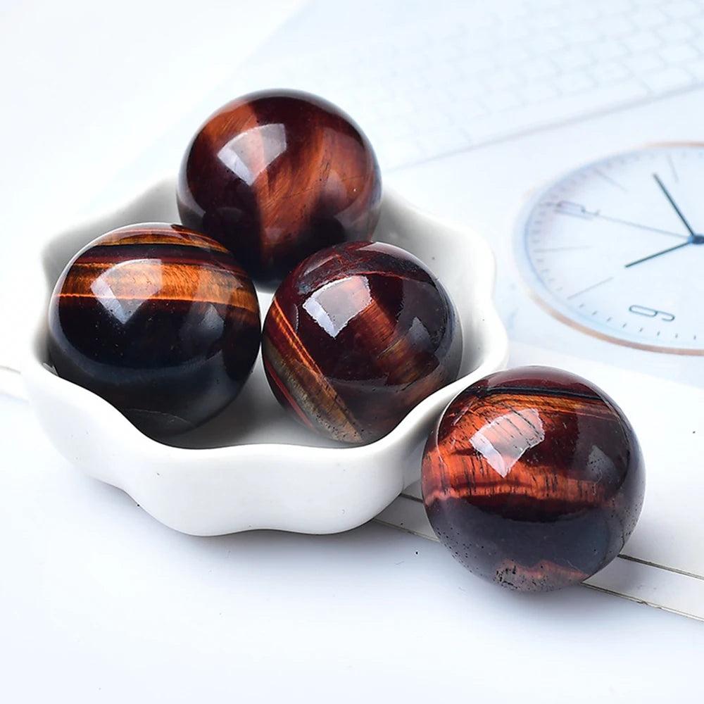 Polished Red Tiger Eye crystal balls with deep crimson bands, perfect for Reiki healing, divination, and home decor.