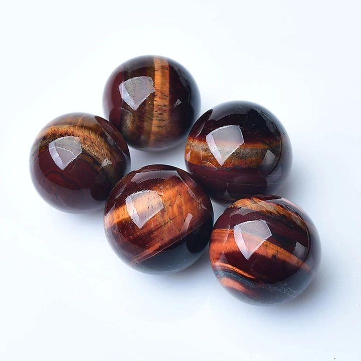 Polished Red Tiger Eye crystal balls with rich mahogany bands, perfect for Reiki healing, divination, and home decor.