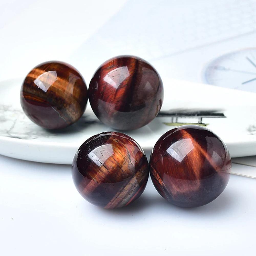 Polished Red Tiger Eye crystal balls with rich, banded mahogany tones for Reiki healing and elegant home decor.