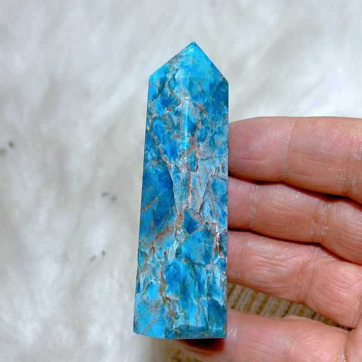 Handheld natural blue flashy apatite tower with vibrant teal hues and unique mineral veining for healing and decor.