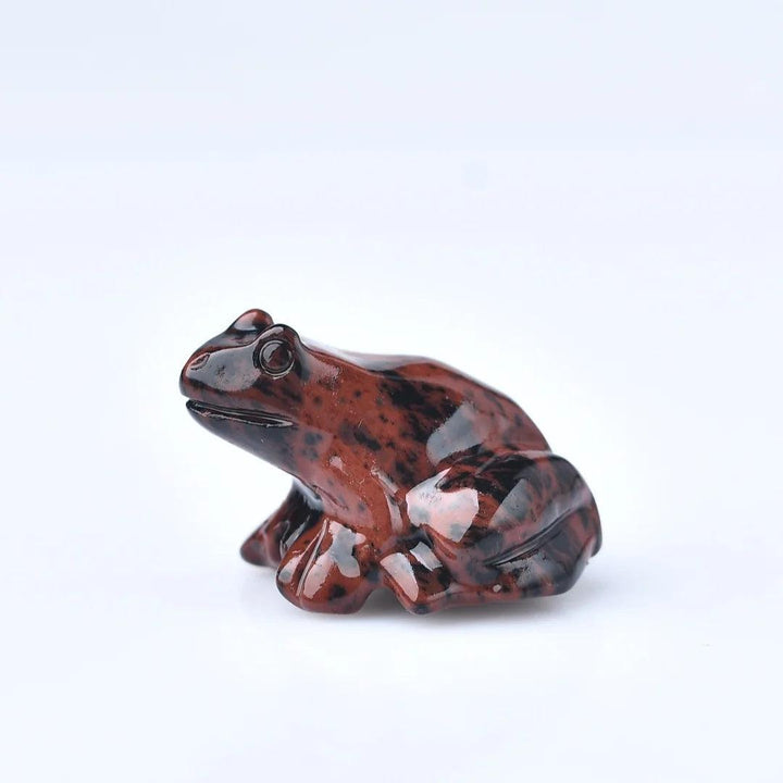 Mahogany Obsidian crystal carved frog figurine, a symbol of transformation and protection.