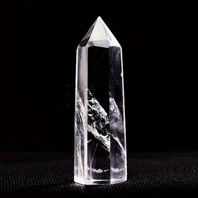 Natural clear quartz crystal hexagonal obelisk wand, a transparent healing stone point for home decor and energy balancing.