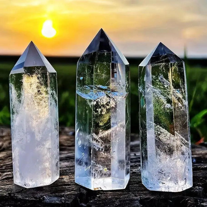 Three transparent clear quartz crystal hexagonal obelisk wands for healing, home decor, and energy balancing.