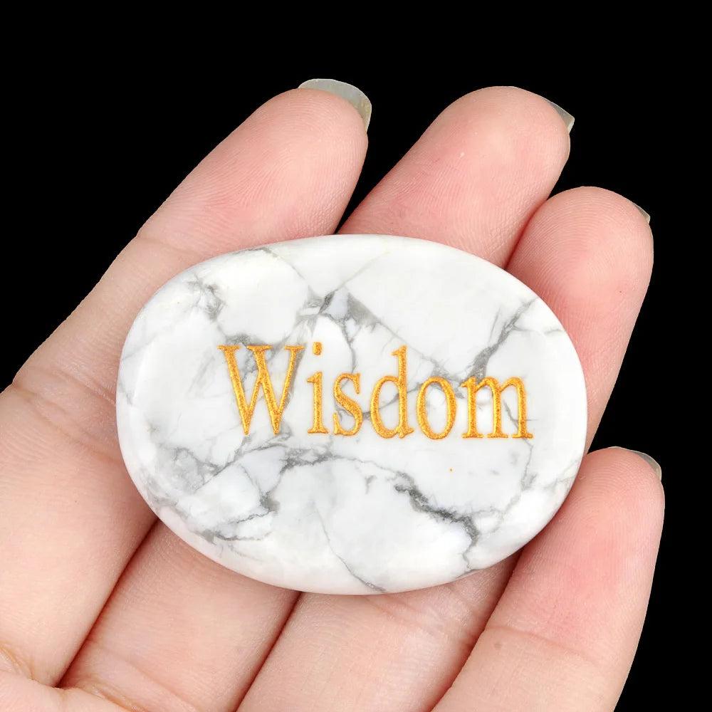 White Turquoise Natural Crystal Engraved Oval Palm Stone with "Wisdom" in gold, promoting clarity and calm.