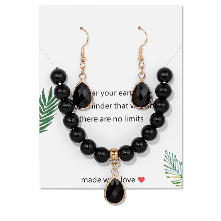 Black Onyx crystal jewelry set featuring a beaded stretch bracelet and matching drop earrings for root chakra grounding.