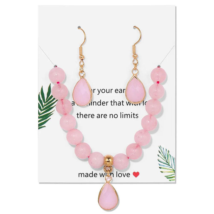 Rose Quartz crystal jewelry set featuring a beaded stretch bracelet and matching heart-chakra drop earrings.