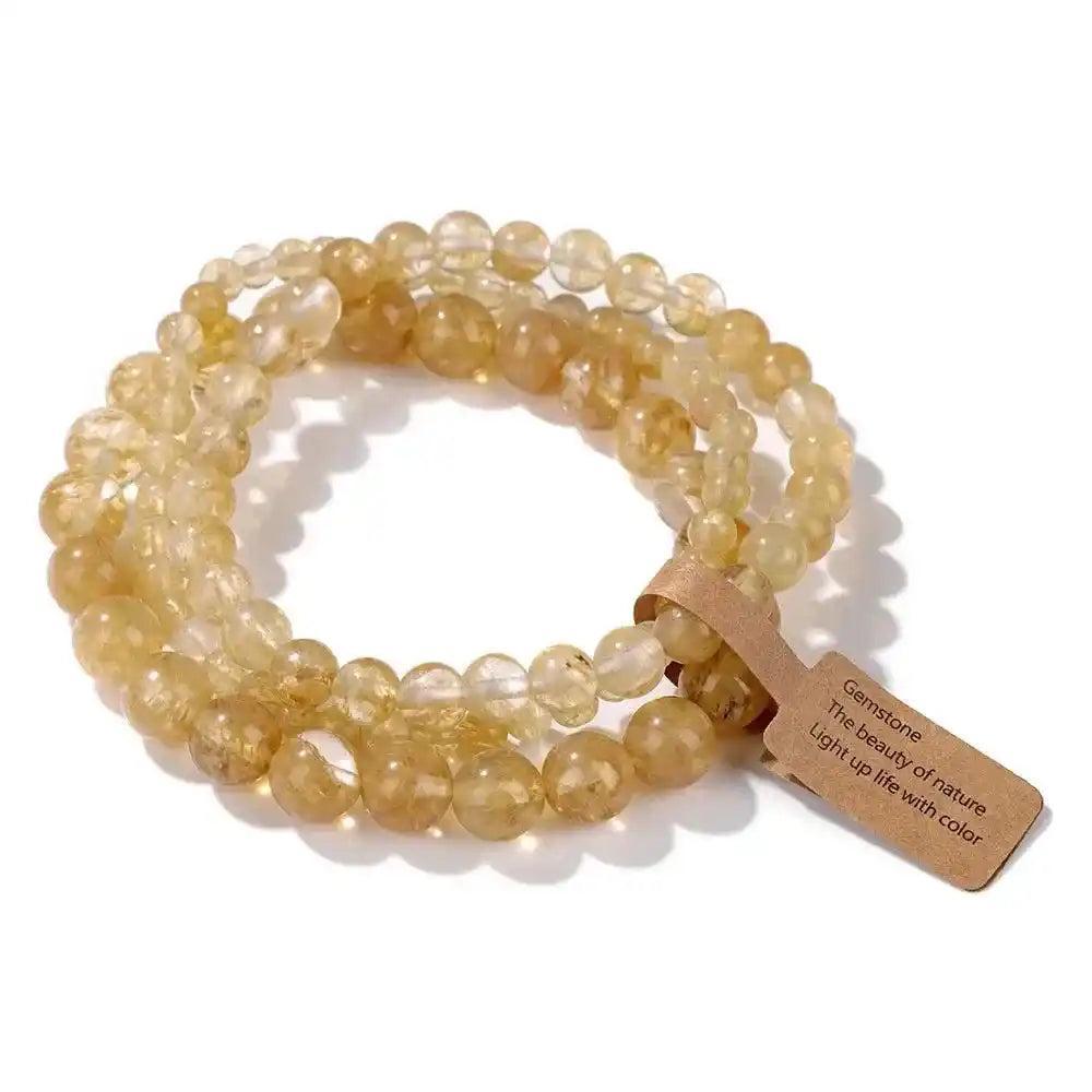 3-Piece Natural Stone Beaded Bracelet Set with warm yellow citrine beads in varying sizes, promoting abundance and joy.
