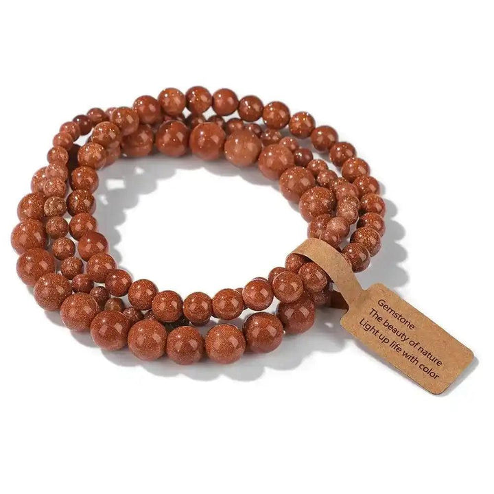 3-Piece Natural Stone Beaded Bracelet Set with shimmering goldstone beads, promoting energy and vitality.