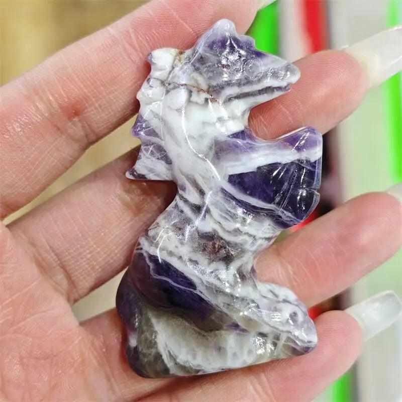 Hand-carved amethyst quartz horse figurine, a polished purple and white crystal gemstone for healing and home decor.