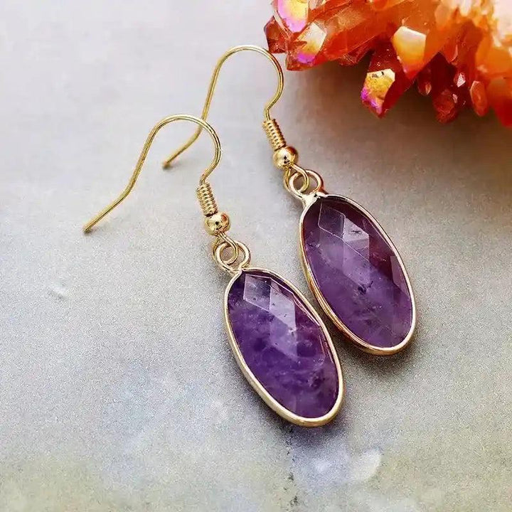 Elegant Amethyst Natural Gemstone Dangle Earrings, featuring polished purple oval stones in refined gold-tone drops.