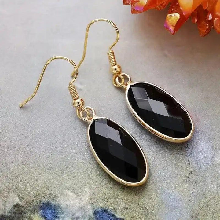 Elegant Black Onyx Natural Gemstone Dangle Earrings with polished, faceted oval stones set in refined gold-tone drops.