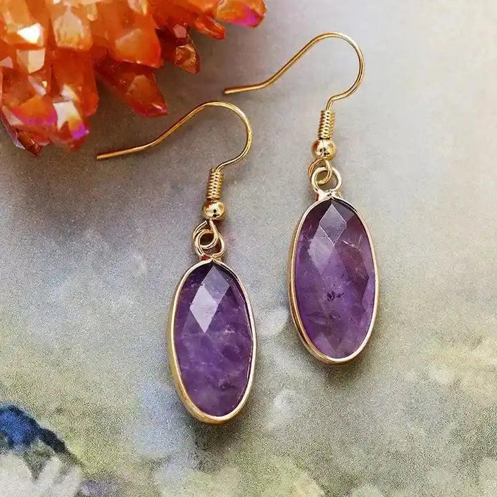 Elegant Amethyst Natural Gemstone Dangle Earrings with faceted oval stones in gold settings, promoting intuition and clarity.