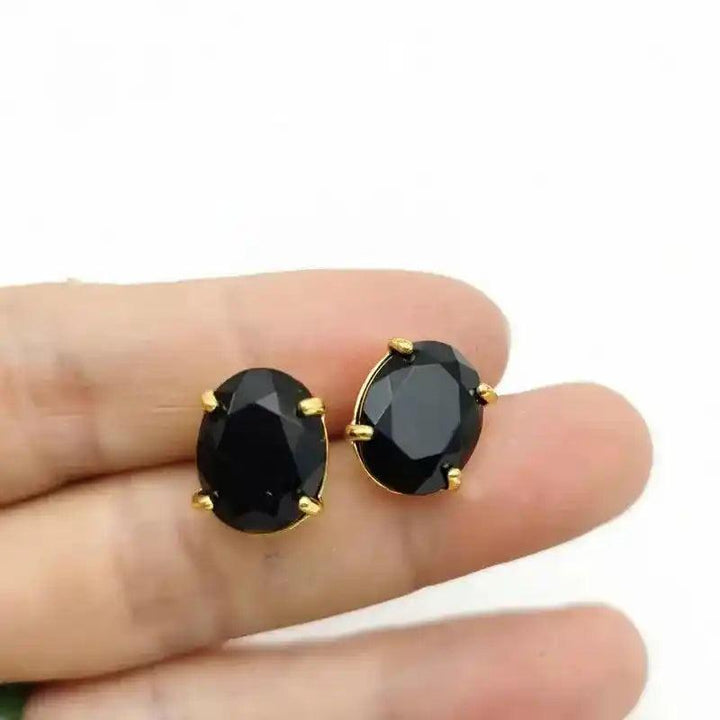 Elegant black oval stud earrings with gold-tone settings.