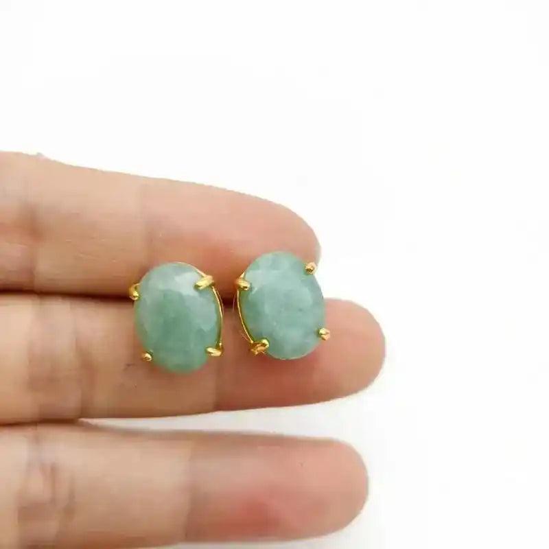Elegant oval green aventurine stud earrings with gold-tone settings, promoting prosperity and well-being.
