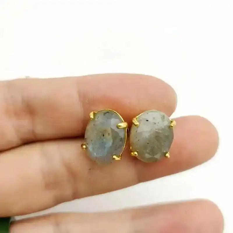Gold-toned oval stud earrings with iridescent labradorite gemstones, promoting wisdom and clarity.