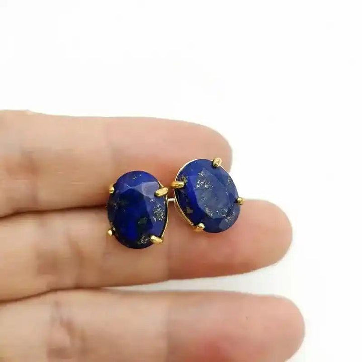 Gold-tone oval stud earrings with deep blue lapis lazuli for wisdom and clarity.
