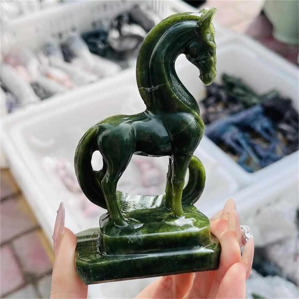 Hand-carved green serpentinite horse figurine featuring deep forest and olive tones for Heart chakra grounding.