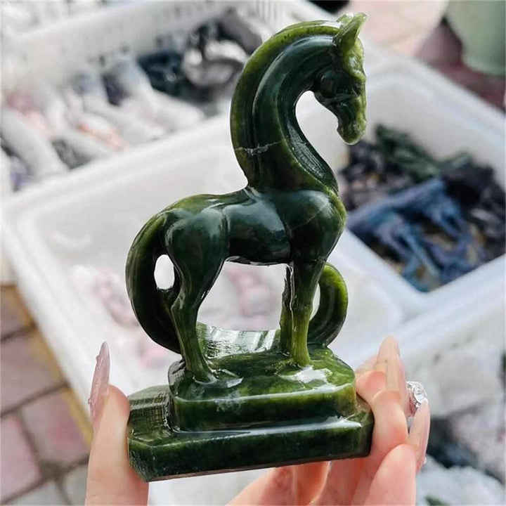 Hand-carved green serpentinite horse figurine featuring deep forest and olive tones for Heart chakra grounding.