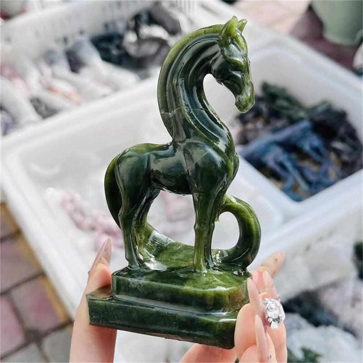 Hand-carved green serpentinite horse figurine featuring deep forest tones and Heart chakra grounding energy.